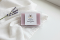 Clean laundry soy wax melt clamshell with soft lavender-pink wax and Merry Bee Apothecary label