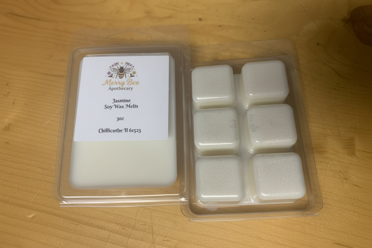 Jasmine soy wax melt clamshell with 6 white square cubes and Merry Bee Apothecary label